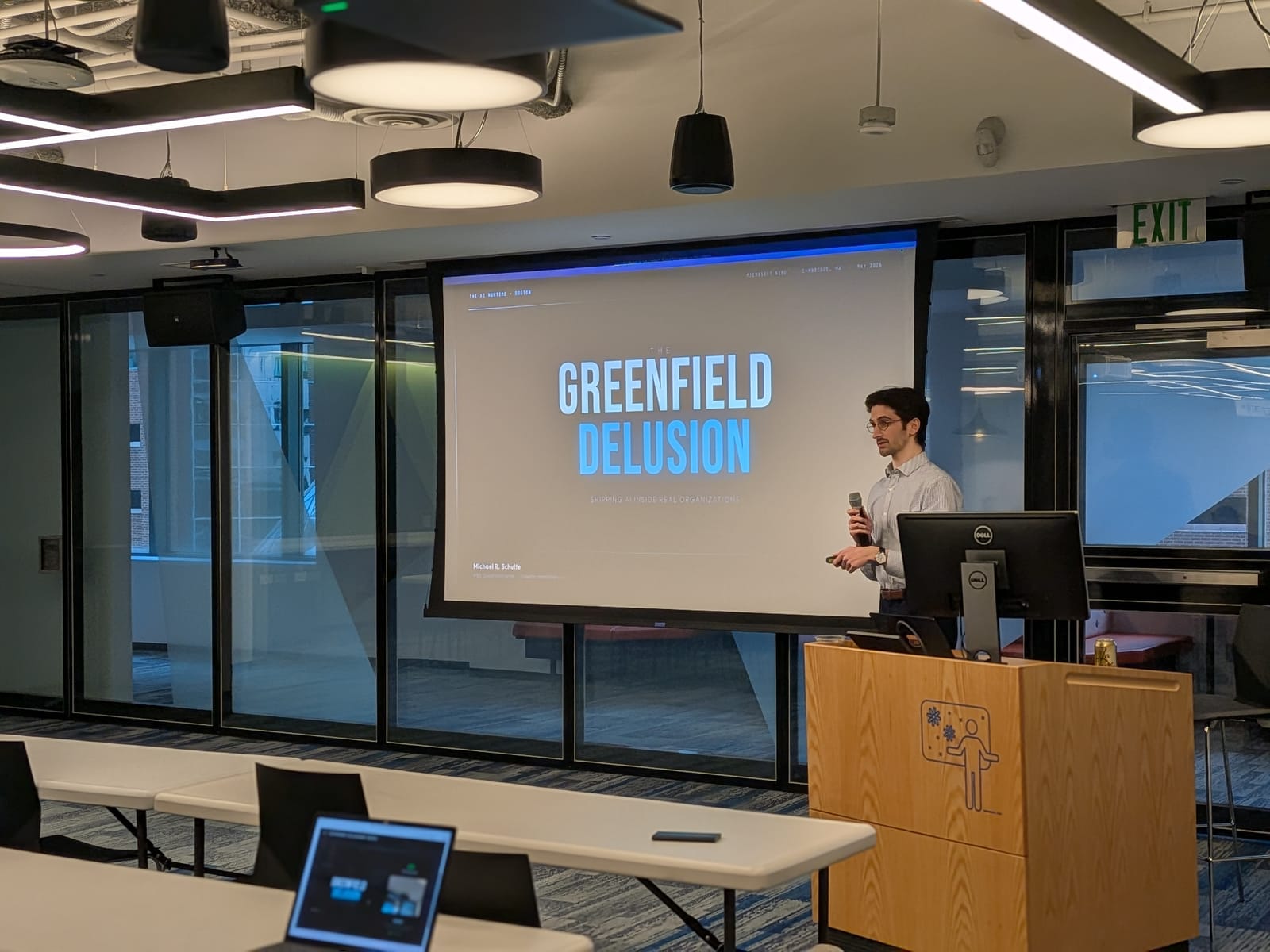 Michael R. Schulte presenting The Greenfield Delusion at the podium